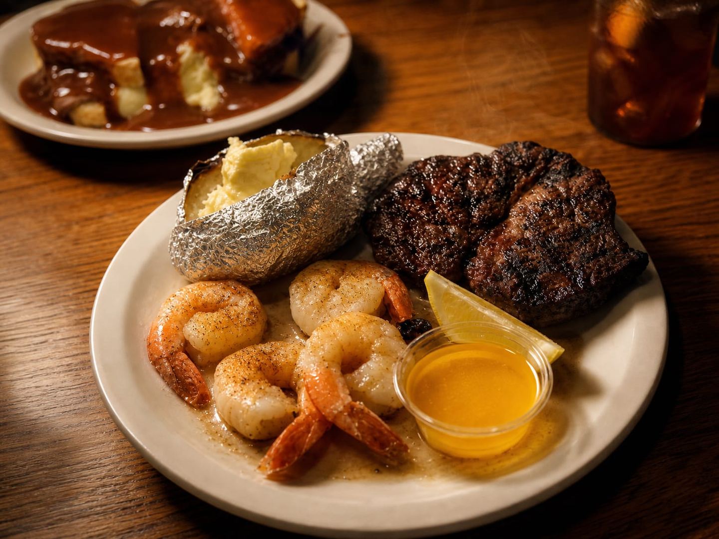 Steak and shrimp dinner plate with a hot beef sandwich under gravy at Now Or Later Restaurant